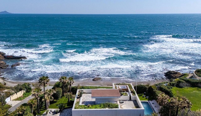 Waterfront luxury villa with a pool and shops within walking distance.